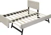A beige upholstered bed frame with a pull-out trundle bed, shown from a slightly elevated diagonal angle against a white background. Náhled obrázku produktu
