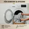 A person is putting a gray blanket into a washing machine. Produktbild-Vorschau