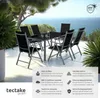 A patio dining set with a table and chairs overlooking the ocean. Produktbild-Vorschau