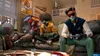 Three people are sitting on a couch playing video games. Produktbild-Vorschau