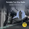 A person wearing a walkie-talkie clipped to their belt. Produktbild-Vorschau