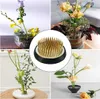 A collage of four images showing different floral arrangements using a flower frog, with a close-up of the flower frog in the center. Produktbild-Vorschau