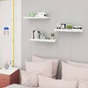 A bedroom scene with shelves mounted on the wall above a bed with pink pillows. Produktbild-Vorschau
