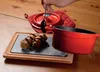 A hand is drizzling chocolate sauce onto cannoli served on a stone slab with a wooden base. Anteprima dell’immagine prodotto