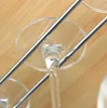 Close-up view of a wine glass rack with chrome rails and clear glass bases. Produktbild-Vorschau