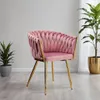 A pink velvet chair with gold legs is shown in a room with plants. Produktbild-Vorschau