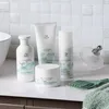 A collection of Wella Nutricurls hair products displayed on a countertop with a tiled backsplash. Voir les images du produit