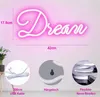 A pink neon sign spelling 'Dream' is displayed on a pink wall, with close-up images of its accessories and features below. Produktbild-Vorschau