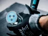 A gloved hand holding a diamond cutting disc for an angle grinder. Anteprima dell’immagine prodotto