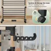 Close-up of a drying rack with a focus on the wheels and a hanger hook. Produktbild-Vorschau