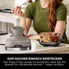 A person is using a Ninja Crispi air fryer in a kitchen setting. Anteprima dell’immagine prodotto