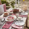 A table set for a tea party with cake, tarts, and floral-patterned dishes. Podgląd zdjęcia produktu