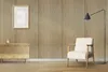 A living room scene with a chair, a floor lamp, a dresser, and a framed picture on a wall with wood paneling. Náhled obrázku produktu