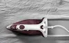 An iron is placed on a wrinkled fabric surface. Produktbild-Vorschau