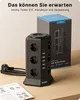 A black Voomy Tower S12 power strip is displayed on a wooden surface, with its packaging box in the background and a manual in the foreground. Produktbild-Vorschau