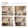 Collage of four images showing a black tree-shaped coat rack in different room settings: a living room with a sofa, a bathroom, an entryway with a shoe rack, and a bedroom with a vanity. Produktbild-Vorschau