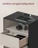 A modern nightstand with a tablet charging on top and a camera on a shelf. Produktbild-Vorschau