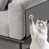 A cat is reaching up to scratch a piece of furniture that has a protective mat attached. Produktbild-Vorschau