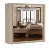 A mirrored wardrobe reflecting a bedroom interior. Voir les images du produit