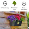 A black planter filled with purple, pink, and yellow flowers is mounted on a wooden wall. Produktbild-Vorschau