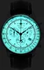 A close-up, illuminated view of a men's chronograph watch with a black leather strap. Náhled obrázku produktu