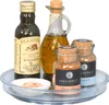 A collection of oils and spices arranged on a rotating tray. Produktbild-Vorschau