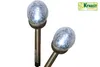 Two solar-powered garden lights with cracked glass globes on white background. Anteprima dell’immagine prodotto