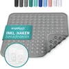 A gray shower mat with a diamond pattern and suction cups on the underside, shown with a teal overlay text and two white adhesive hooks. Produktbild-Vorschau
