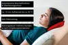 A woman is lying on a couch with her eyes closed, resting her head on a red heating pad. Produktbild-Vorschau