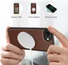 A person is holding a phone case with a MagSafe charger attached, demonstrating its features. Produktbild-Vorschau
