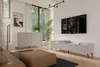 A modern living room with a beige dresser, a TV stand with a TV, a coffee table, and a floor lamp. Podgląd zdjęcia produktu