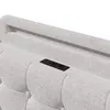 Close-up of a light gray upholstered headboard with button tufting and a built-in charging station. Produktbild-Vorschau