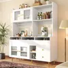 A white kitchen hutch with glass doors and gold accents, filled with kitchenware and appliances. Produktbild-Vorschau