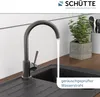 A kitchen faucet with water running into a sink, next to a potted plant. Produktbild-Vorschau