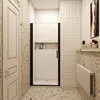 A modern bathroom with a shower cabin, a door, and a radiator. Produktbild-Vorschau