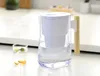 A water filter pitcher and a glass of infused water on a kitchen counter. Podgląd zdjęcia produktu
