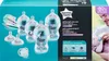 A box of Tommee Tippee advanced anti-colic baby bottles and accessories, with a father feeding a baby on the right side. Produktbild-Vorschau