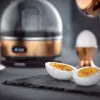 A close-up shot of a kitchen appliance and cooked eggs, with a focus on the product's design and presentation. Náhľad obrázku produktu