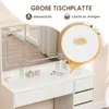 A close-up view of a white vanity table with a mirror, showcasing its features and demonstrating its water-resistant and easy-to-clean surface. Produktbild-Vorschau