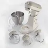 A kitchen mixer and its accessories are displayed on a white background. Náhled obrázku produktu
