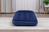 A blue inflatable mattress is placed on a rug in a room with curtains in the background. Náhľad obrázku produktu