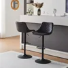 Two black bar stools in a modern kitchen or dining area. Produktbild-Vorschau