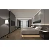 A modern hotel room with two beds, a desk, and a floor lamp. Anteprima dell’immagine prodotto