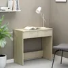 A desk with a book and a lamp on it, next to a plant and a chair. Podgląd zdjęcia produktu