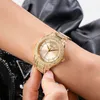 A close-up shot of a person's wrist wearing a gold Guess watch. Podgląd zdjęcia produktu
