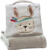 A folded baby blanket with a stuffed animal face design on the top part. Produktbild-Vorschau