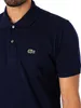 Close-up of a man wearing a navy blue Lacoste polo shirt. Produktbild-Vorschau