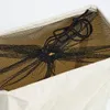 A close-up view of the top opening of a beige laundry basket, showing a black mesh drawstring bag inside. Anteprima dell’immagine prodotto