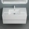 A white bathroom vanity with a sink and faucet, mounted on a gray wall. Produktbild-Vorschau