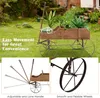 A wooden wagon planter filled with plants, shown outdoors on a grassy lawn. The image is split into two sections, with the top showing the wagon in a garden setting and the bottom showing close-ups of its features. Produktbild-Vorschau